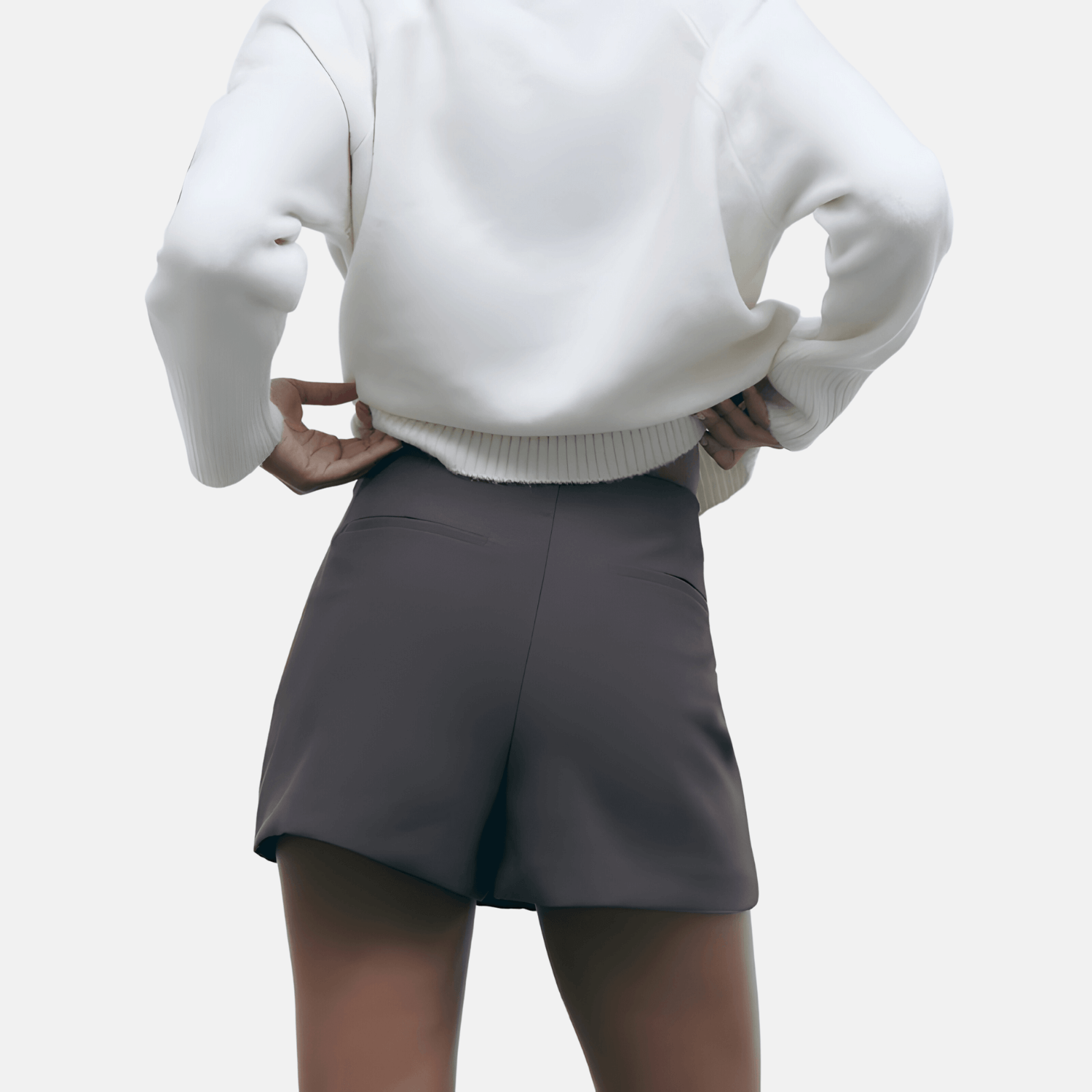 Back view of a model wearing the gray Barbie Shorts Skirt, highlighting the back pockets and tailored fit.