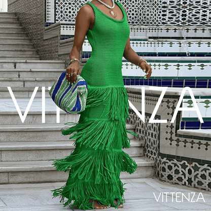 Side view of the green Bahamas dress on a model, highlighting its fitted silhouette and multi-layered fringe design.