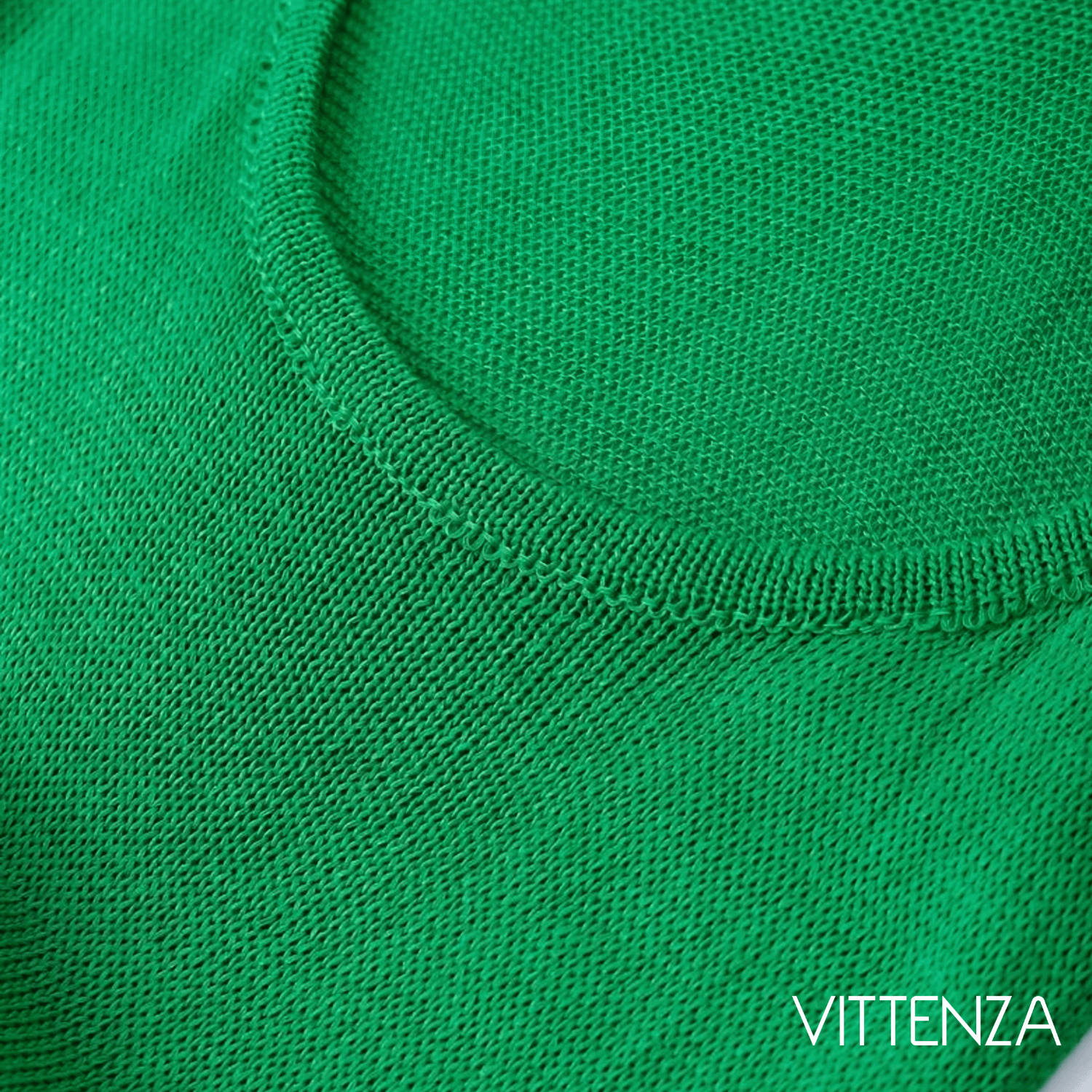 Close-up view of the neckline of the green Bahamas dress, showcasing the fine knit fabric.