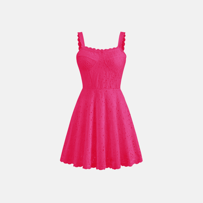 Front view of the pink Bali Dress, showcasing its vibrant color and intricate embroidery details on the bodice and straps.