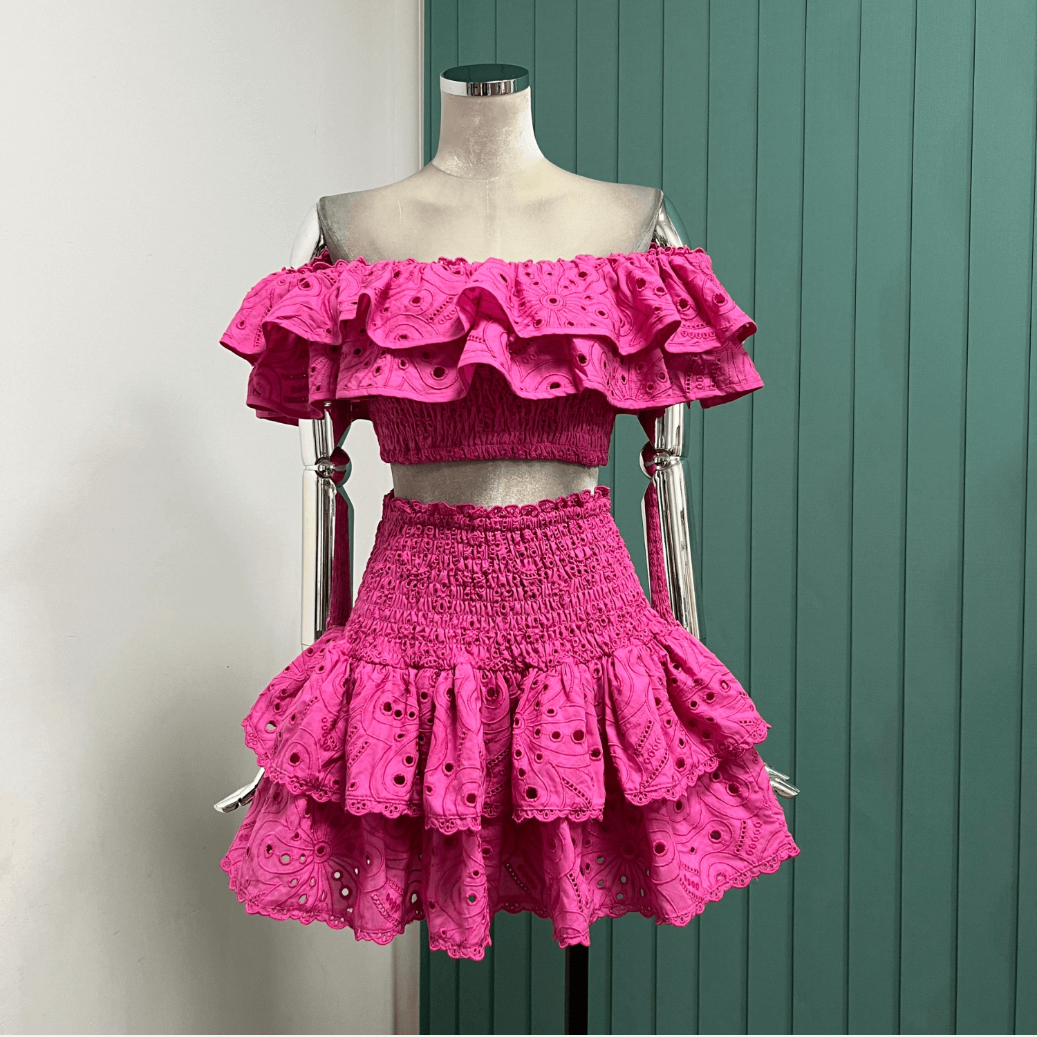 Gummy Set displayed on a mannequin, showcasing the vibrant pink ruffled crop top and matching double-ruffle skirt.