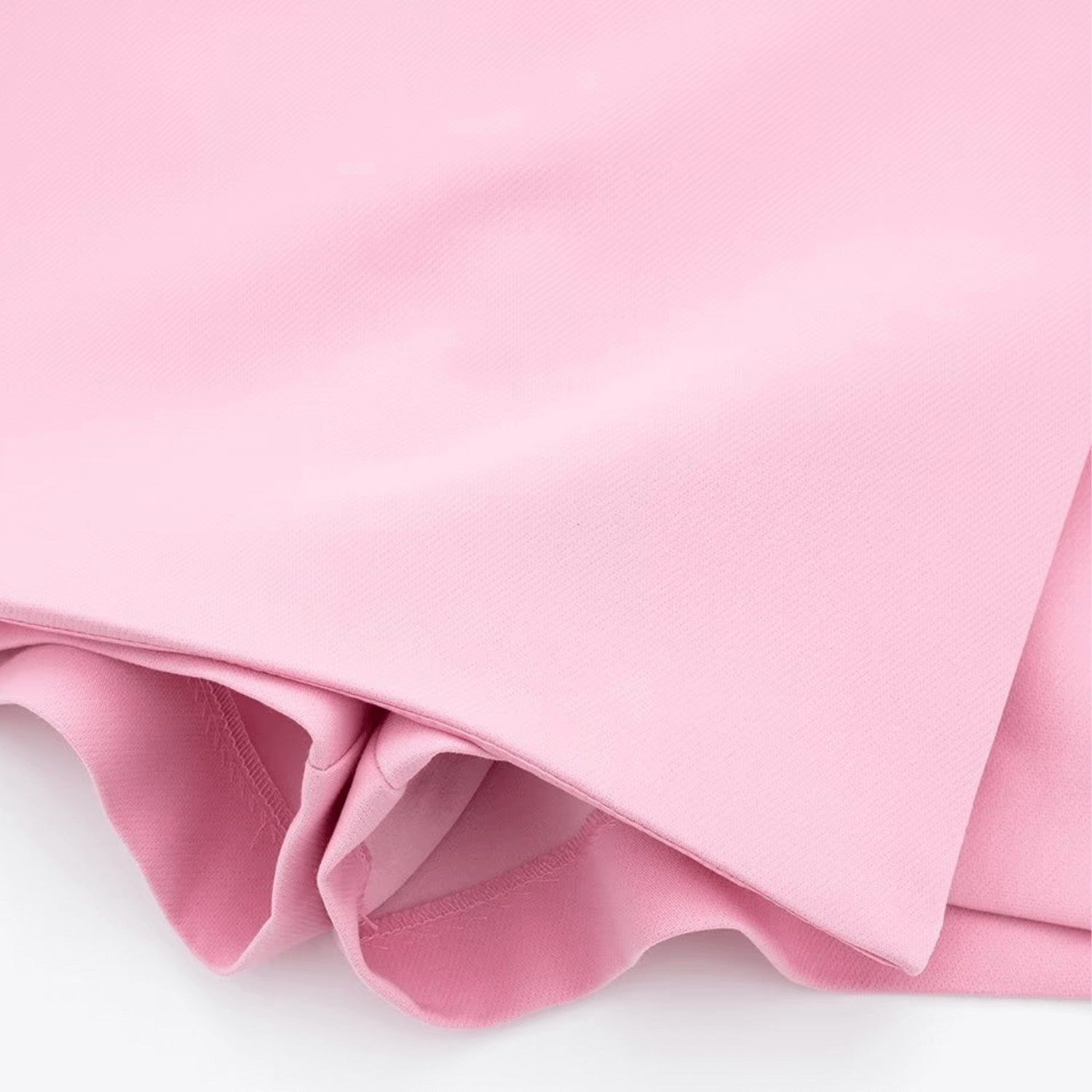 Close-up of the fabric and hem detail on the pink Barbie Shorts Skirt, emphasizing quality and texture.