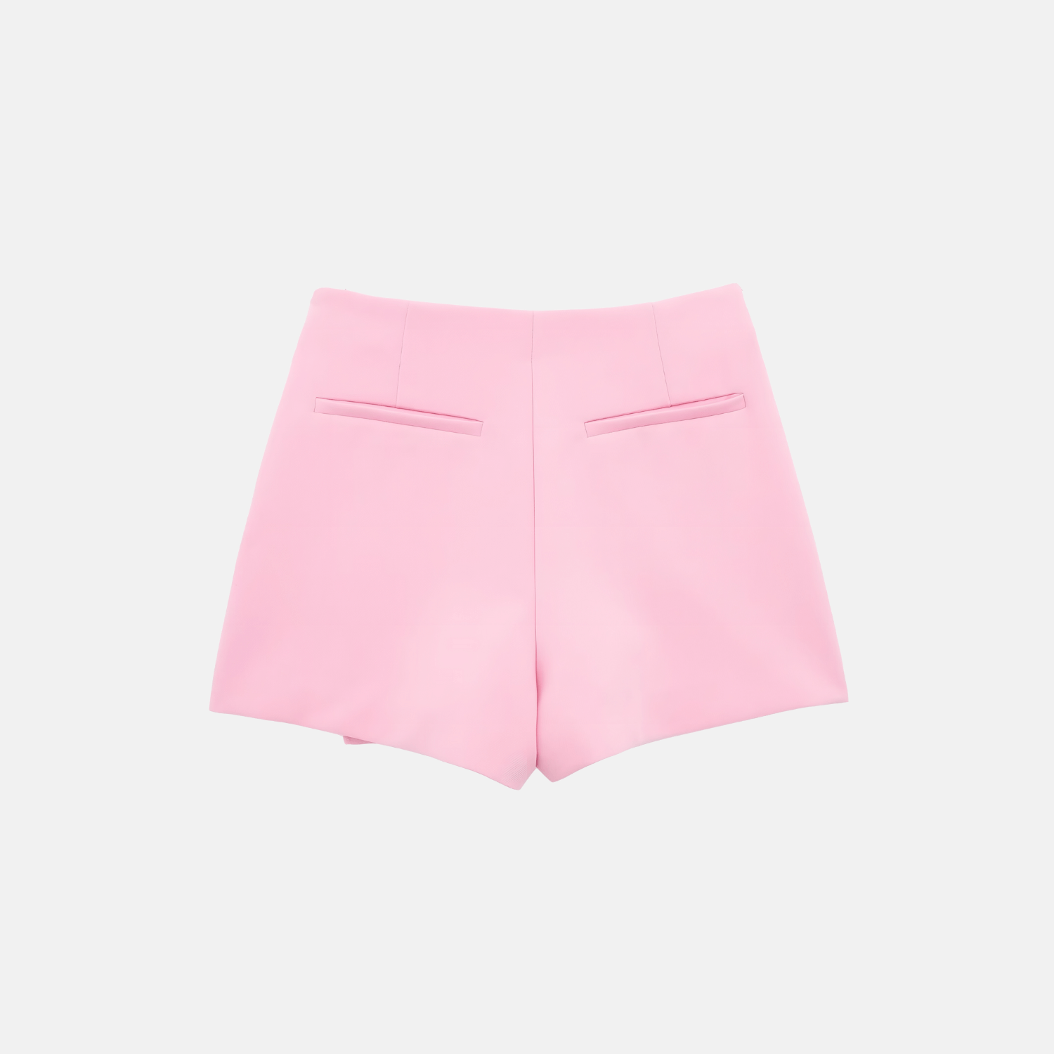 Back view of the pink Barbie Shorts Skirt in flat lay, highlighting the back pockets and sleek tailoring.