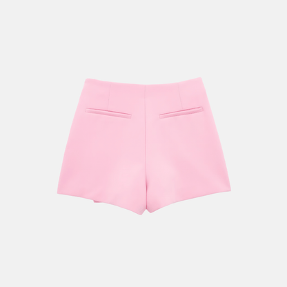 Back view of the pink Barbie Shorts Skirt in flat lay, highlighting the back pockets and sleek tailoring.