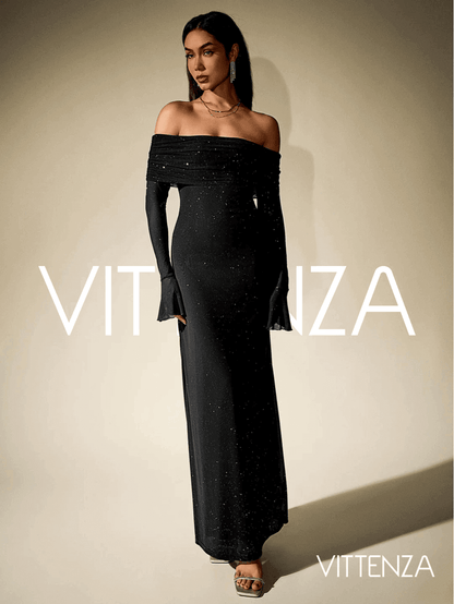 Angled front view of the Stellar Sparkle Maxi Dress in shimmering black, highlighting the off-shoulder design, glittering details, and floor-length silhouette. The model pairs the dress with statement earrings and metallic heels.