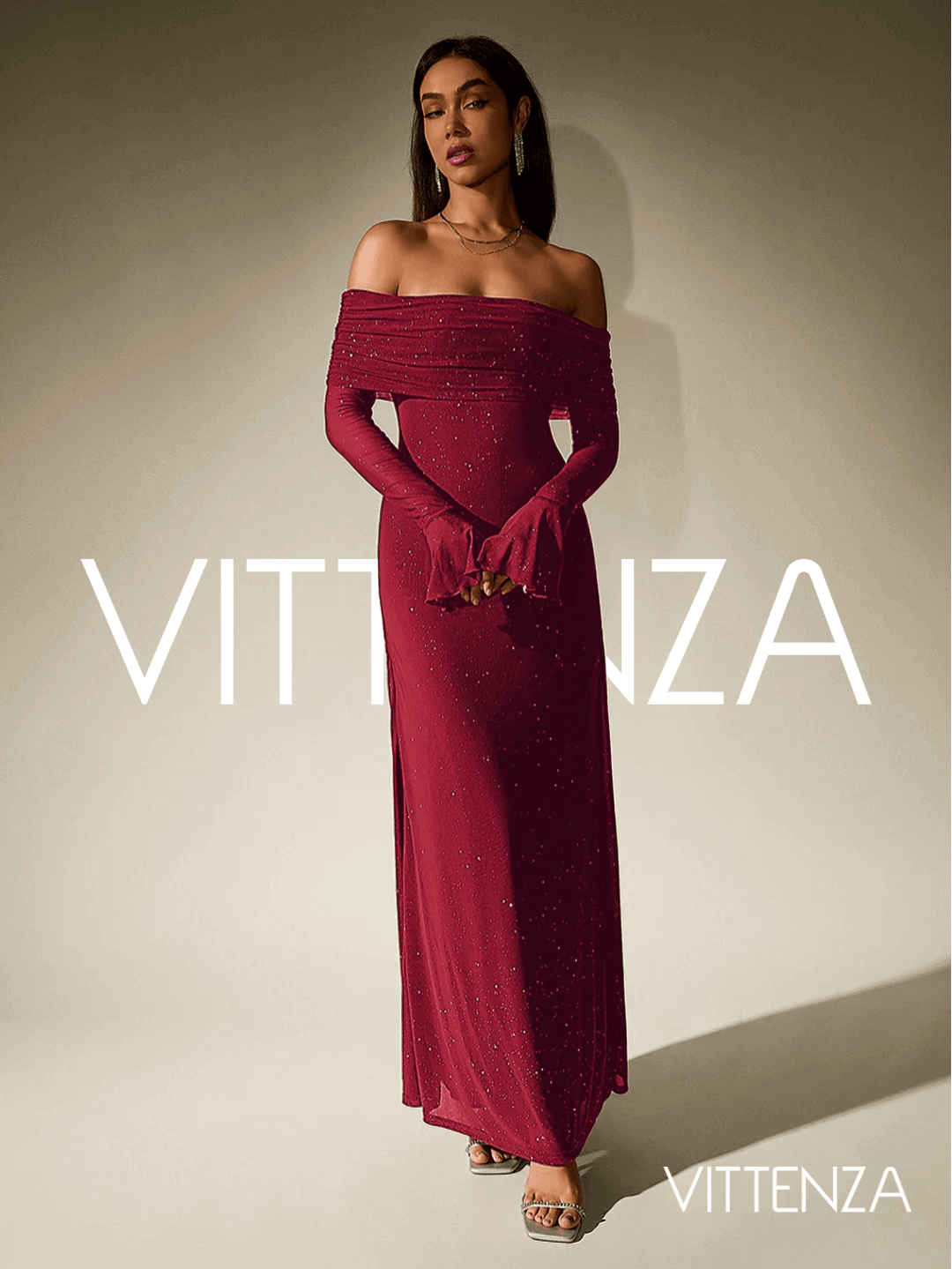 Full front view of the Stellar Sparkle Maxi Dress in shimmering red. Features an elegant off-shoulder design, long sleeves with flared cuffs, and a floor-length silhouette. The model accessorizes with delicate jewelry and strappy heels.