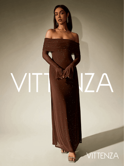 Full view of the Stellar Sparkle Maxi Dress in shimmering brown. The off-shoulder design, glittering fabric, and elegant long sleeves create a sophisticated silhouette. The model wears minimal accessories and heeled sandals.